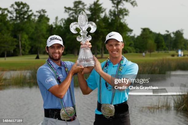 Davis Riley of the United States and Nick Hardy of the United States pose with the trophy and commemorative belts after their win during the final...