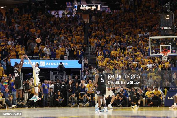 Harrison Barnes of the Sacramento Kings attempts, but misses, a shot over Stephen Curry of the Golden State Warriors at the end of game Game Four of...