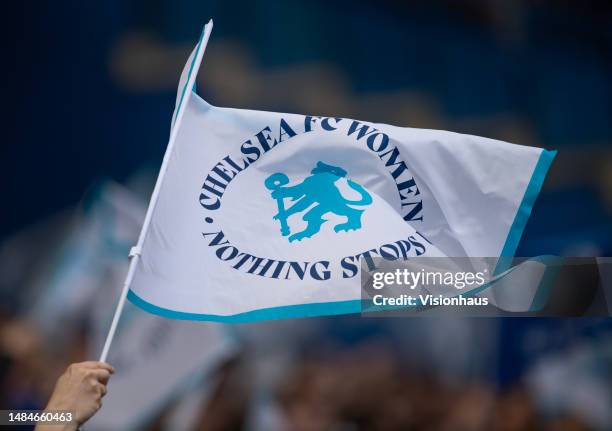 Fans wave Chelsea Women flags during the UEFA Women's Champions League semifinal 1st leg match between Chelsea FC and FC Barcelona at Stamford Bridge...