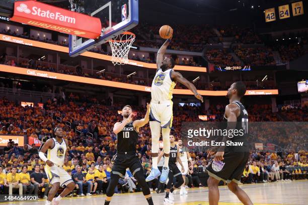 Draymond Green of the Golden State Warriors dunks the ball on Domantas Sabonis of the Sacramento Kings in the second half of Game Four of the Western...