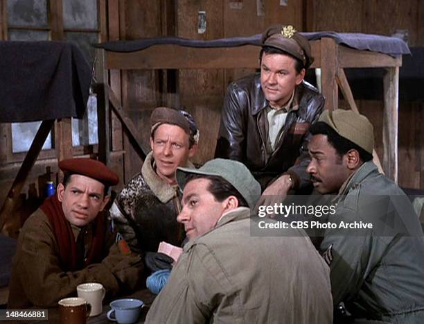 Clockwise from left: Robert Clary as Cpl. Louis LeBeau, Larry Hovis as Sgt. Andrew Carter, Bob Crane as Col. Robert E. Hogan, Ivan Dixon as Sgt....