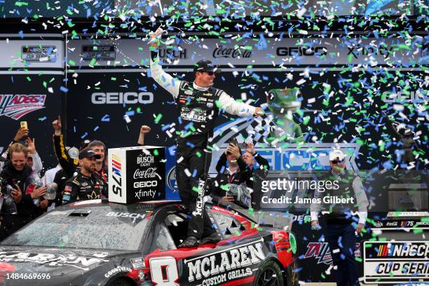 Kyle Busch, driver of the McLaren Custom Grills Chevrolet, celebrates in Victory Lane after winning the NASCAR Cup Series GEICO 500 at Talladega...