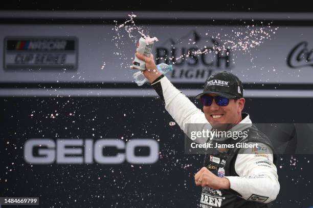 Kyle Busch, driver of the McLaren Custom Grills Chevrolet, celebrates in Victory Lane after winning the NASCAR Cup Series GEICO 500 at Talladega...