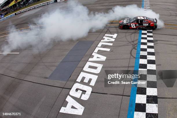 Kyle Busch, driver of the McLaren Custom Grills Chevrolet, celebrates with a burnout after winning the NASCAR Cup Series GEICO 500 at Talladega...