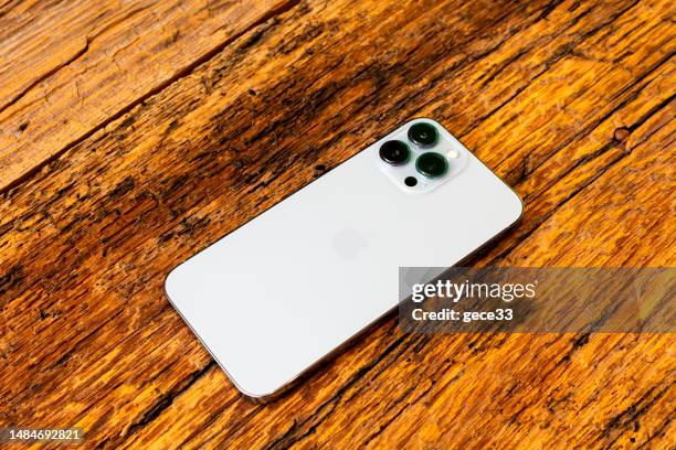 iphone 14 pro on wooden table - iphone camera interface stock pictures, royalty-free photos & images