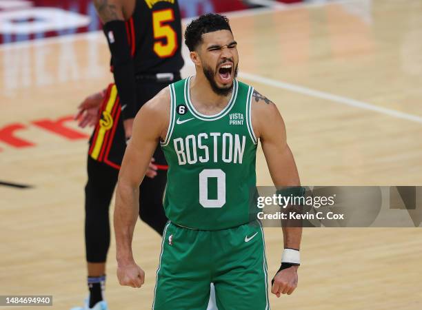 Jayson Tatum of the Boston Celtics reacts after hitting a three-point basket against the Atlanta Hawks during the fourth quarter of Game Four of the...