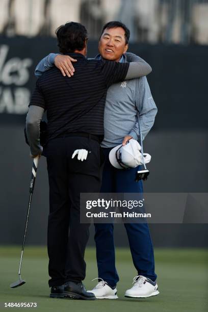 Charlie Wi of South Korea congratulates Mark Hensby of United States on winning the Invited Celebrity Classic at Las Colinas Country Club on April...