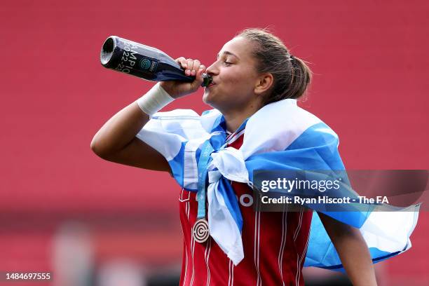 Abi Harrison of Bristol City drinks from a Champions 2022-23 Bottle, whilst wearing the National Flag of Scotland and winners medal, as players of...