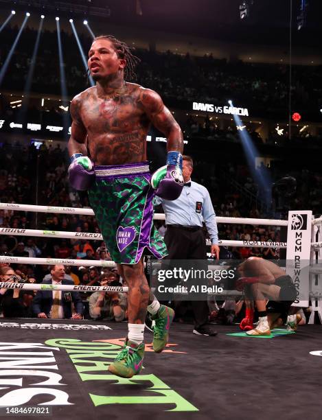 Gervonta Davis in the green and purple trunks reacts after defeating Ryan Garcia in the black trunks by knockout in the seventh round during their...