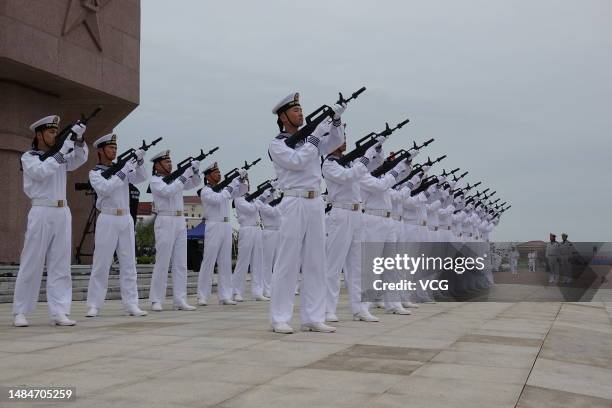 The honour guard perform three-volley salute to pay tribute to martyrs during a ceremony to celebrate the 74th anniversary of the founding of the...