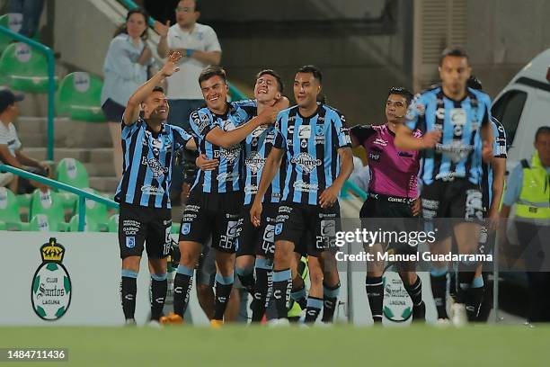 Ettson Ayon of Queretaro celebrates with teammates after scoring the team´s second goal during the 16th round match between Santos Laguna and...