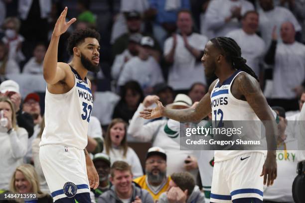 Karl-Anthony Towns of the Minnesota Timberwolves celebrates with Taurean Prince during the fourth quarter against the Denver Nuggets at Target Center...