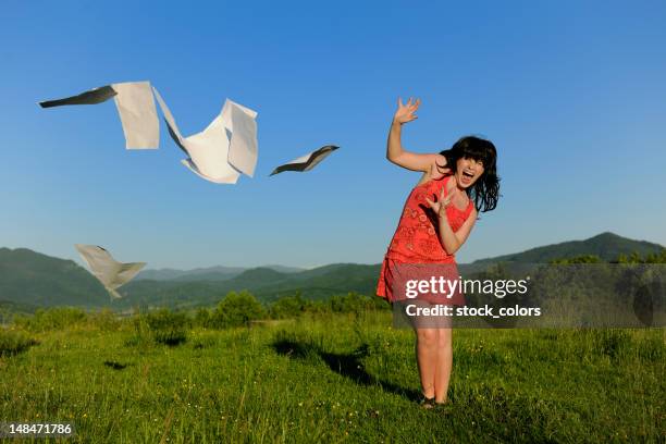 woman throwing papers - paper blowing stock pictures, royalty-free photos & images