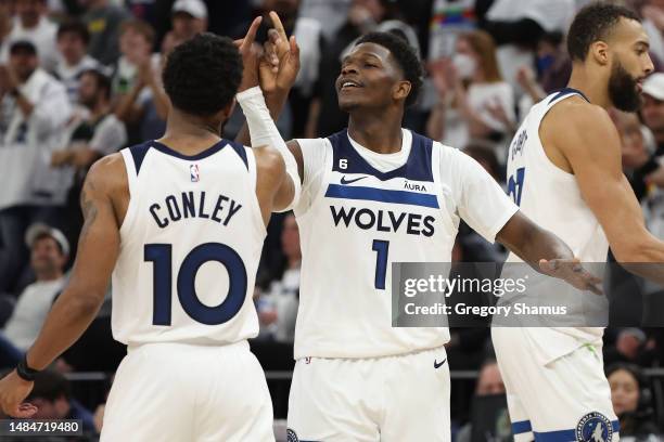 Anthony Edwards of the Minnesota Timberwolves celebrates with Mike Conley during overtime against the Denver Nuggets at Target Center on April 23,...