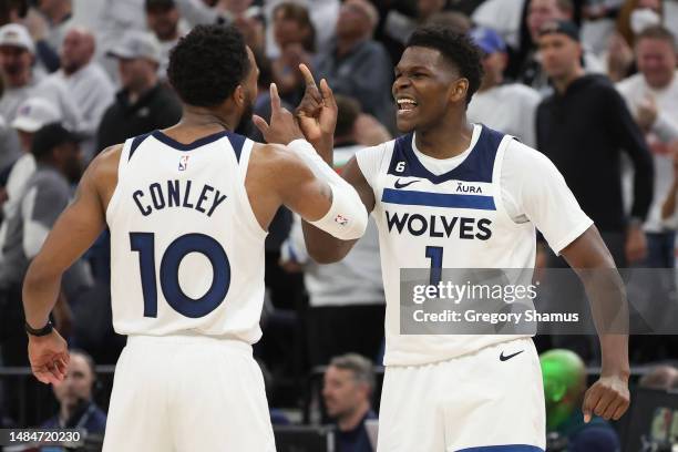 Anthony Edwards of the Minnesota Timberwolves celebrates with Mike Conley during overtime against the Denver Nuggets at Target Center on April 23,...