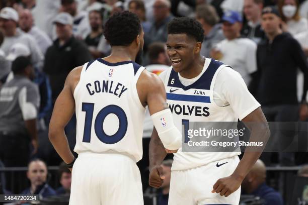 Anthony Edwards of the Minnesota Timberwolves celebrates with Mike Conley during overtime against the Denver Nuggets at Target Center on April 23,...