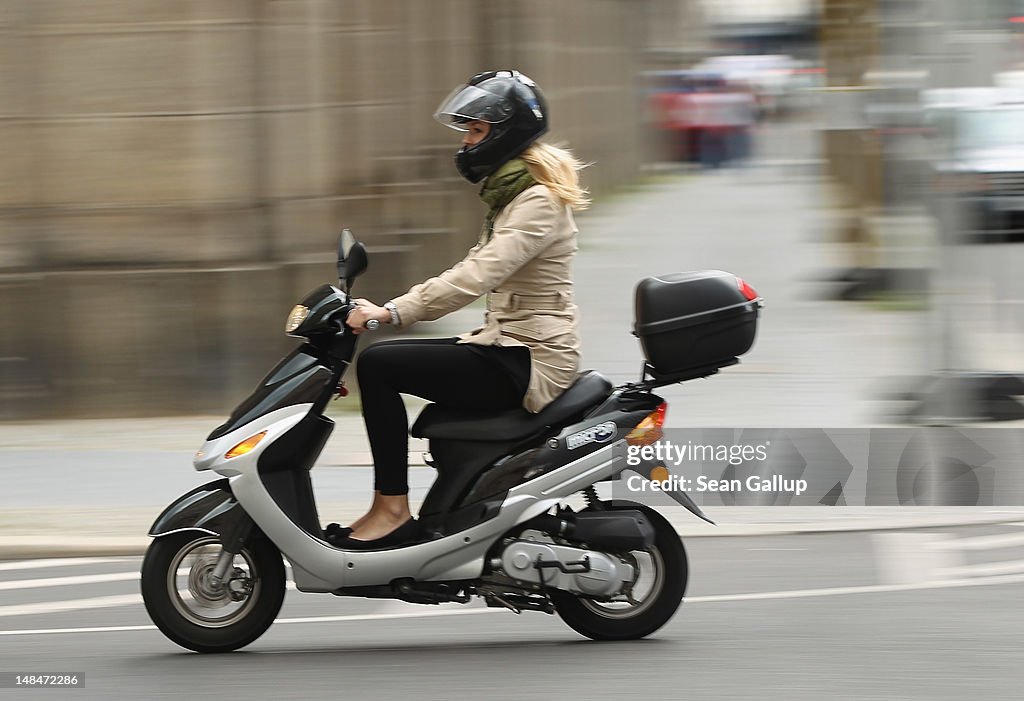 Young Woman On A Moped