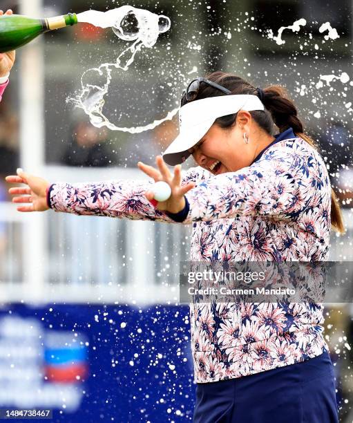 Lilia Vu of the United States is sprayed with champagne in celebration of winning on the number 18 first-playoff hole against Angel Yin of the United...