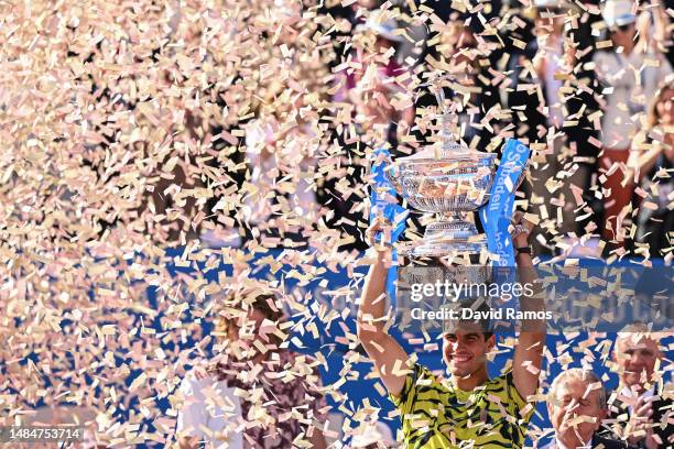 Carlos Alcaraz of Spain lifts the winners trophy after beating Stefanos Tsitsipas of Greece during the Men's Singles Final on Day Seven of the...