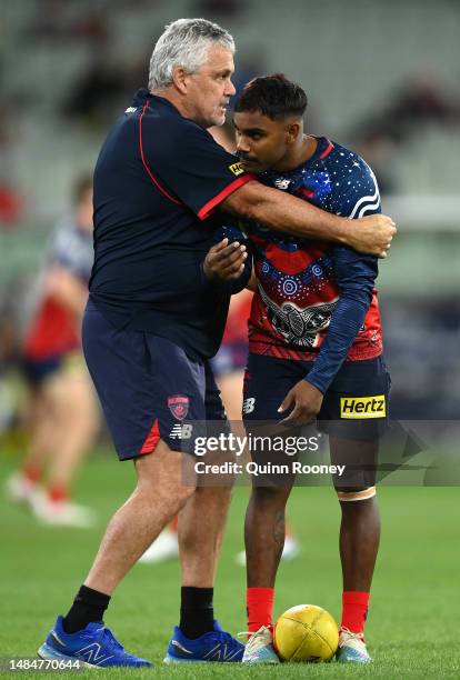 Kysaiah Pickett of the Demons is hugged by Mark Williams the assistant coach of the Demons during the round six AFL match between Melbourne Demons...