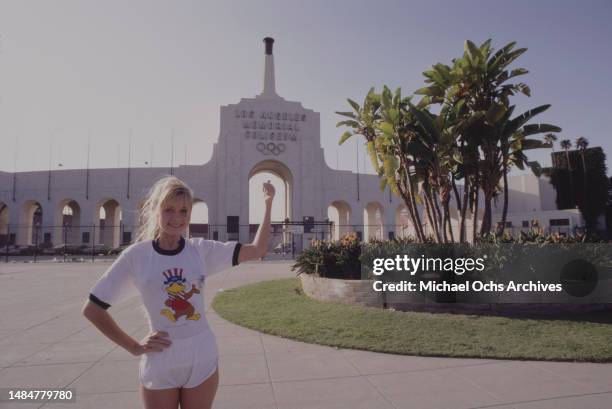 Young woman wearing a t-shirt featuring Sam the Olympic Eagle, the official mascot for the 1984 Summer Olympics, outside the Los Angeles Memorial...