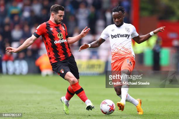Maxwel Cornet of West Ham United is challenged by Lewis Cook of AFC Bournemouth during the Premier League match between AFC Bournemouth and West Ham...