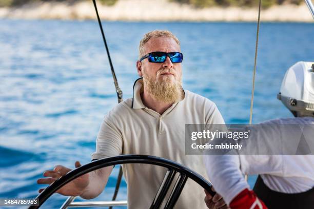 skipper sailing on sailboat - ship captain stock pictures, royalty-free photos & images