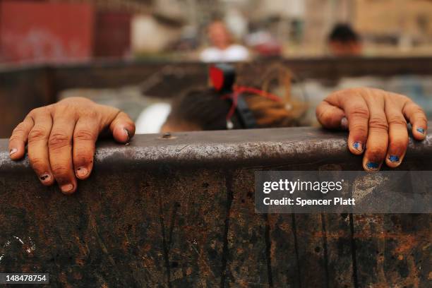 Child plays in a dumpster in a gang infested neighborhood on July 17, 2012 in Tegucigalpa, Honduras. Honduras now has the highest per capita murder...