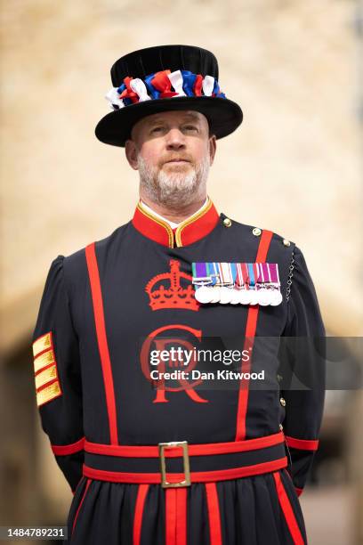 Yeoman Sergeant Clive Towell poses for a portrait wearing his new uniform featuring King Charles III's new insignia at the Tower of London on April...