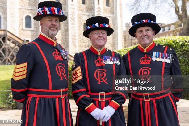 Yeoman warders pose for a portrait wearing their new uniform featuring King Charles III's new insignia at the Tower of London on April 24, 2023 in...