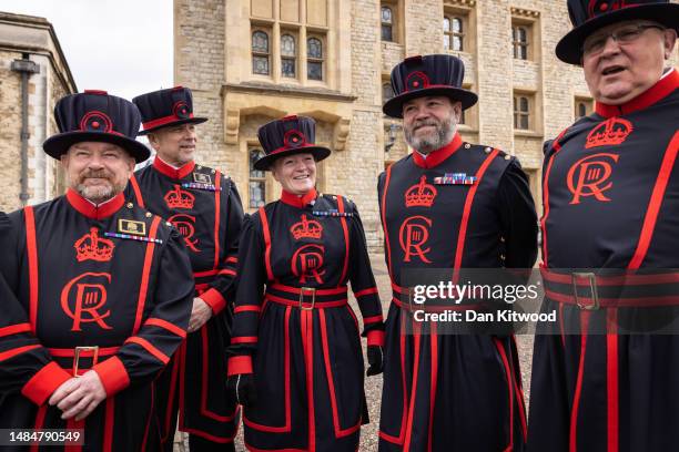 Yeoman warders pose for a portrait wearing their new uniform featuring King Charles III's new insignia at the Tower of London on April 24, 2023 in...