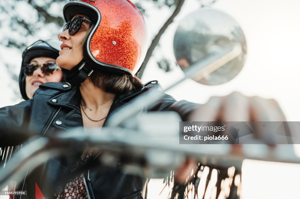 Women outdoors with motorbike