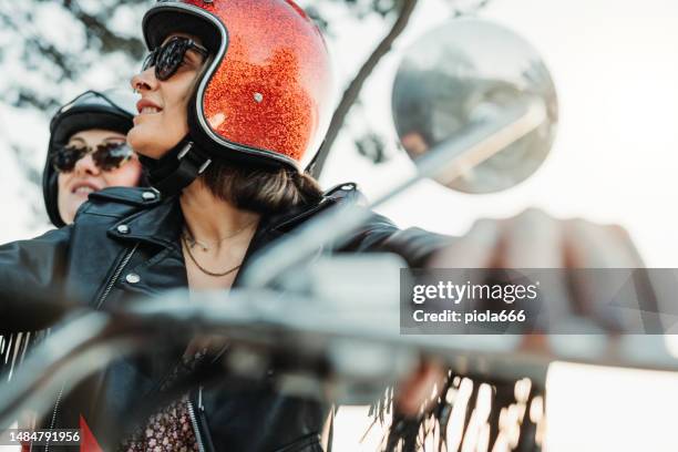 women outdoors with motorbike - passeio em veículo motorizado imagens e fotografias de stock