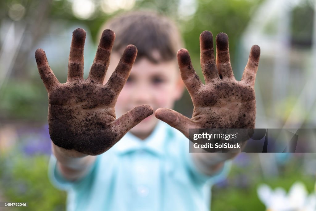 Showing his Muddy Hands