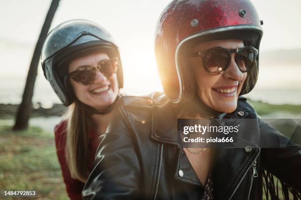 women outdoors with motorbike - motorbike stock pictures, royalty-free photos & images