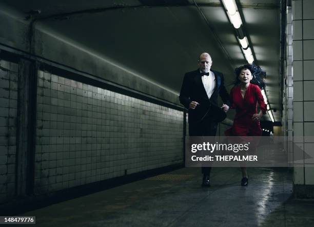 elegant couple running - red dress run stock pictures, royalty-free photos & images