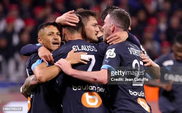 Cengiz Under of Marseille celebrates his goal with Alexis Sanchez, Jordan Veretout during the Ligue 1 Uber Eats match between Olympique Lyonnais and...