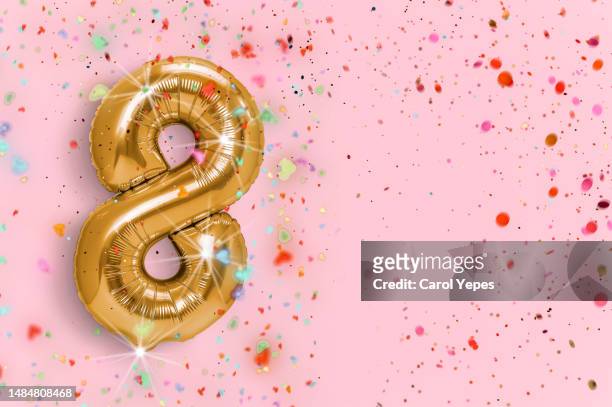 number eight in golden foil balloon - balloons and streamers stock pictures, royalty-free photos & images