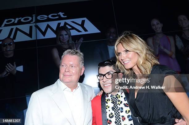 Designers Bert Keeter and Mondo Guerra pose with model Heidi Klum at the Project Runway Life-Sized Interactive Runway installation on The High Line...