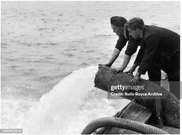 Undated May 1952: Raising the HMS Warspite Battleship May 1952 - Rolls-Royce Derwent V aero engines were used as air pumps to expel sea water from...