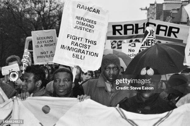 Crowd members hold banners and placards during a protest organised by RAHCAR against the government's Asylum Bill, London, 21st November 1992.