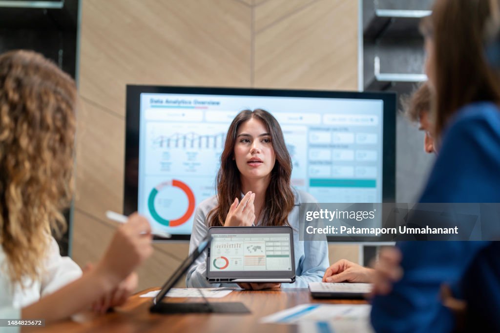 Cultivate members in the organization to share idea to develop the organization to advance. Executive business development team brainstorming and share idea on the new project using digital tablet. Businesswoman manager present the market trend