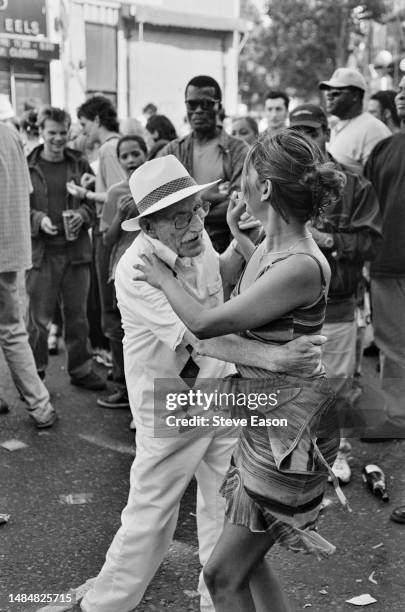An elderly man enjoys a dance with a woman at the Notting Hill Carnival in West London, 29th August 1999.