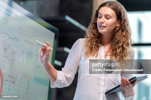 efficient presentation of the work drives the business to grow steadily. businesswoman sale manager present the data analysis information to management team in the meeting room and point to the important information. - customer data stock pictures, royalty-free photos & images