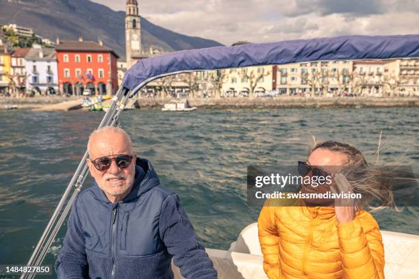 father and daughter enjoying a day out on a boat - ascona 個照片及圖片檔