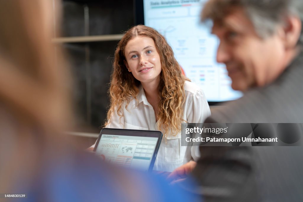 Product launch incentives can take turns for business growth. Businesswoman explain the strategic plan to launch the new product via digital table to sale team in the meeting room at office. Brainstorming and share idea to launch new product to customer.
