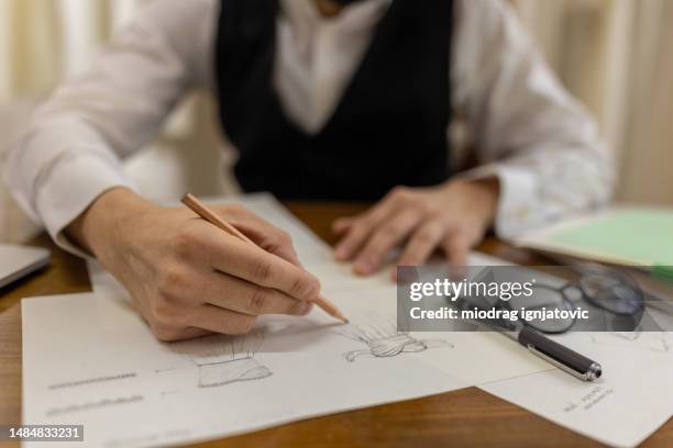 fashion designer working on new wedding dress design in bridal shop - fashion stylist stock pictures, royalty-free photos & images