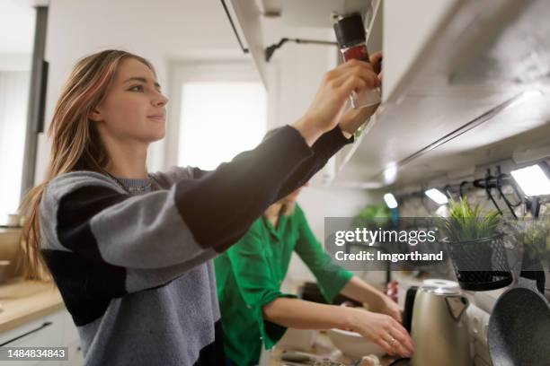 mother and daughter working in kitchen - generation z food stock pictures, royalty-free photos & images