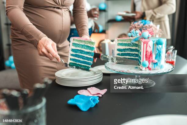 blue surprise cake at a gender reveal party - gender reveal stock pictures, royalty-free photos & images