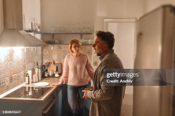 couple having a fight in the kitchen - preparing food talking stock pictures, royalty-free photos & images